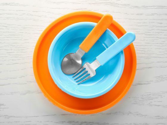 child's blue bow with orange plate and spoon & fork