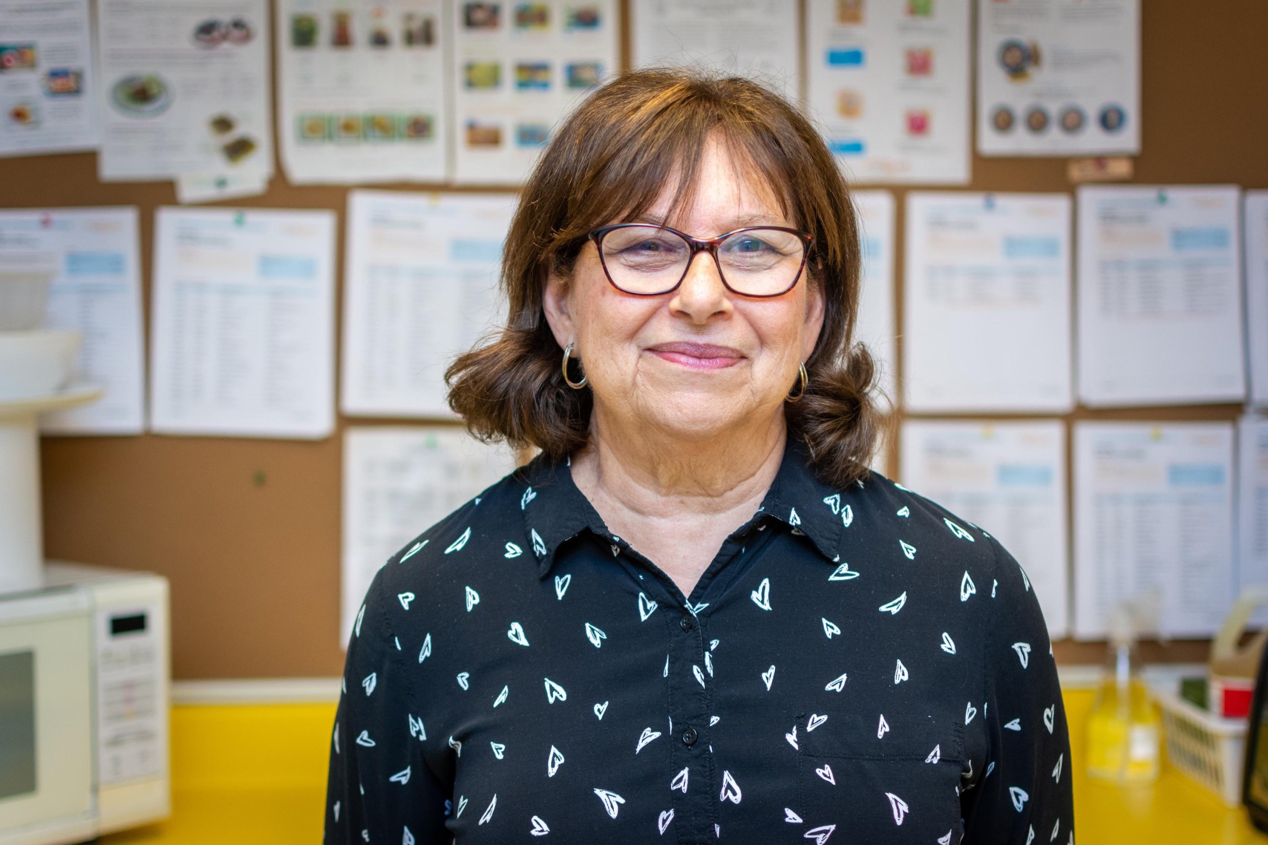 woman in black shirt in glasses in child care class