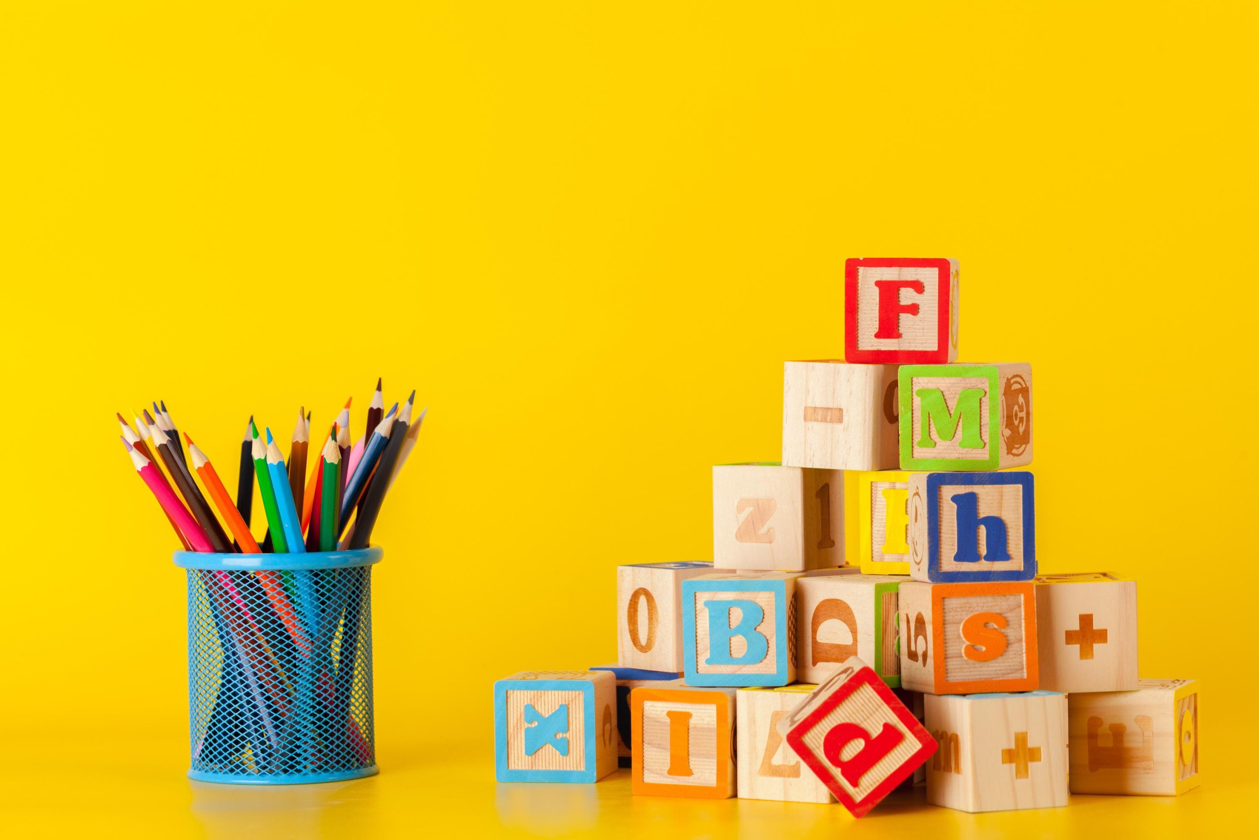 Colorful wooden blocks and cup with colorful pencils