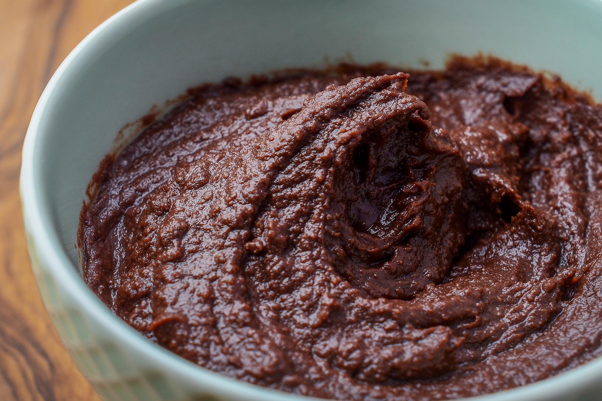 close up blue bowl with chocolate chickpea spread