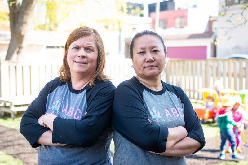 two women arms crossed outside day care