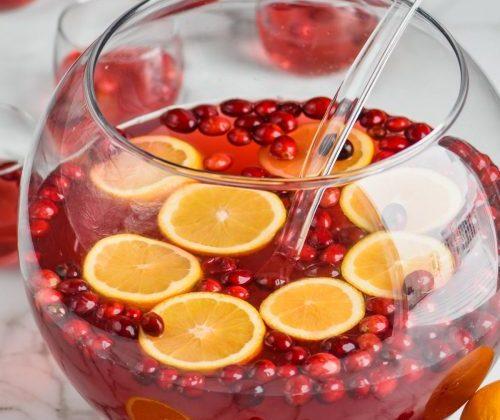 glass punch bowl with cranberries and orange slices