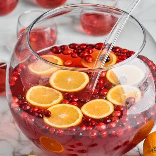 glass punch bowl with cranberries and orange slices