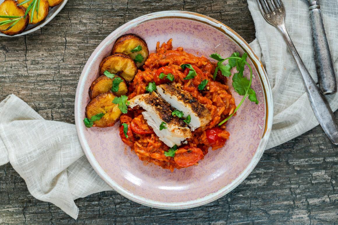 plate of west african jollof rice with side of plantain rounds