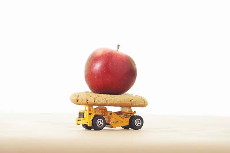 apple on cookie on toy truck