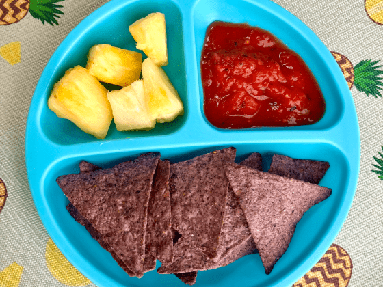 RFRK tomato salsa with blue corn tortilla chips and pineapple chunks in a blue divided child's plate