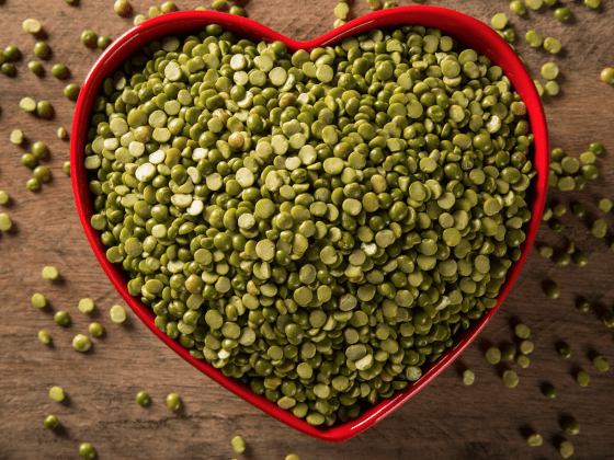 centred image of green lentils in a heart shaped dish