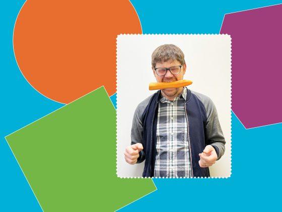 Ryan, Products & Services Coordinator at RFRK, poses with a carrot clenched between his teet