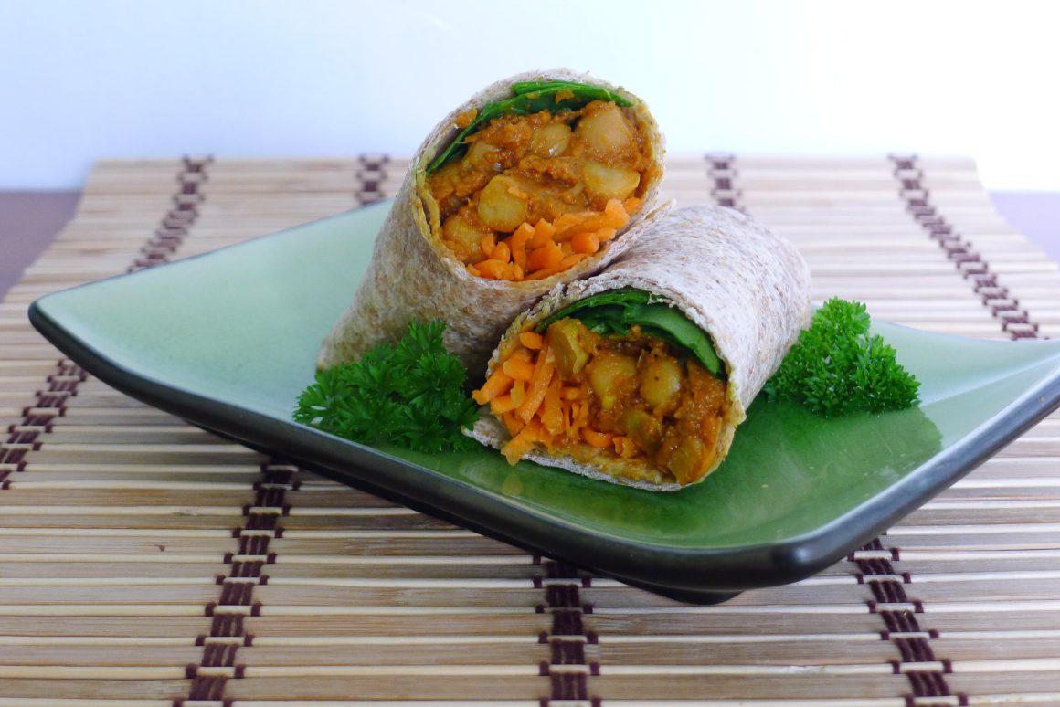 pumpkin roti wrap stacked on top of each other green plate filled with carrots