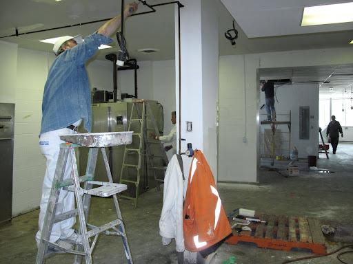 man on ladder working on customizing RFRK facility space