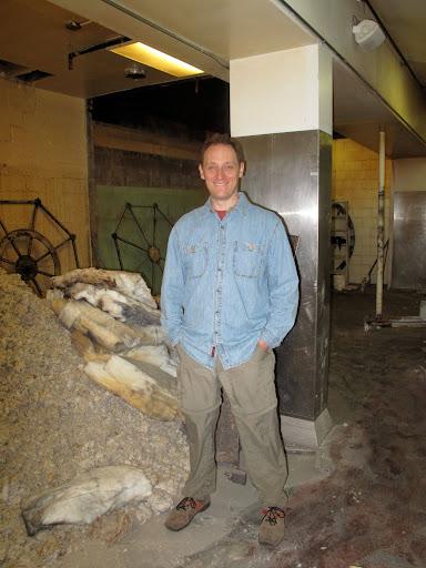 Man smiling in front of construction phase of new space