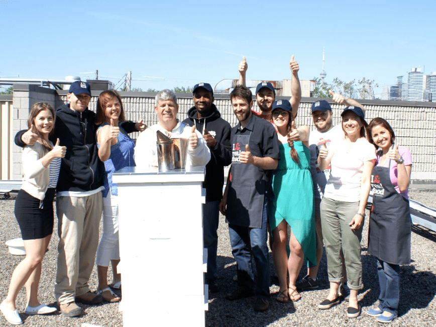 group of staff members celebrating rooftop bees at RFRK 