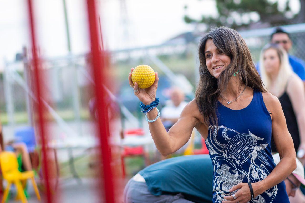 woman, lulu from RFRK, tossing a ball at fam jam 2019 event