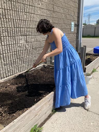 Woman tends to garden bed soil RFRK saulter faciity