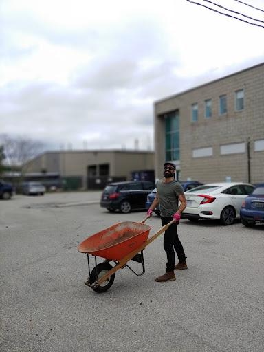 man with wheel barrow in front of RFRK saulter street facility