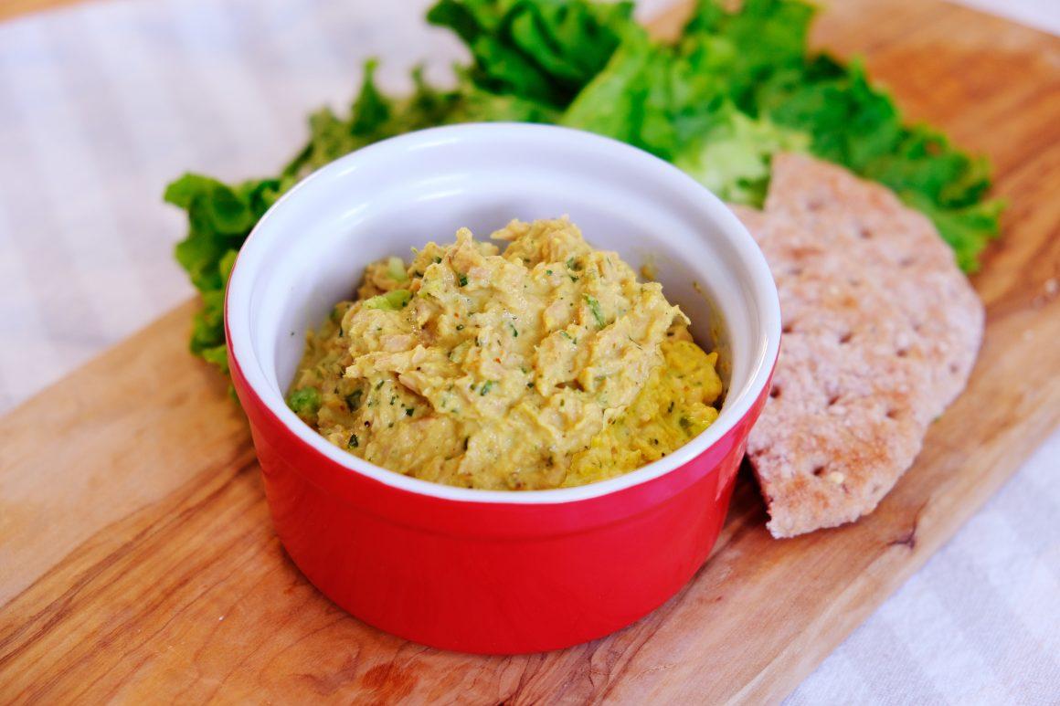 a bowl of curried tuna salad in a red and white ramekin