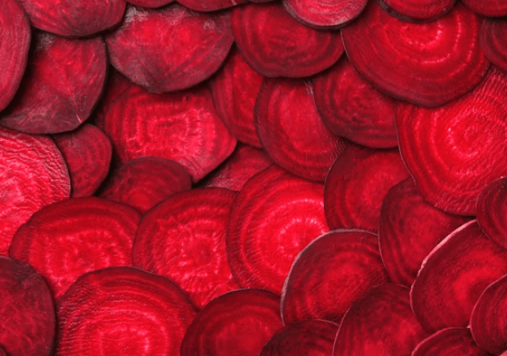 close up of a large group of purple beet coins with a hint of red
