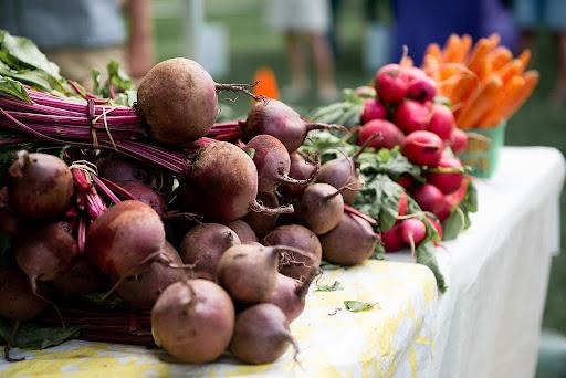 display of fresh root vegetables at farmers market