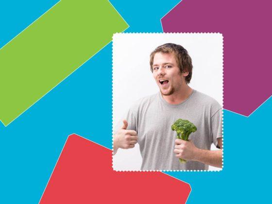 man with gray shirt posing for a meet our team photo, doing a thumbs up and holding broccoli in front of colourful background