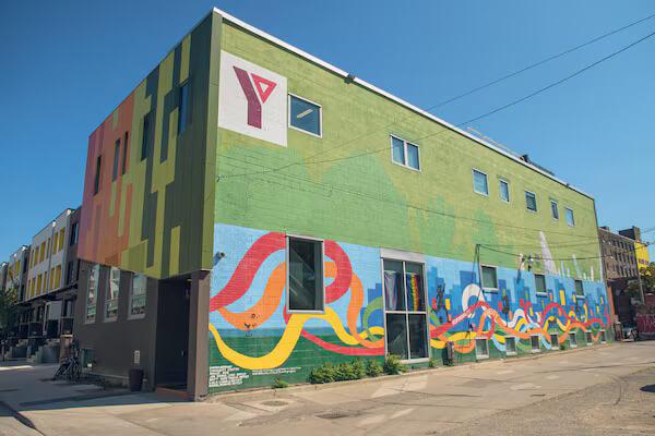 ymca wagner green building with colourful murals on walls