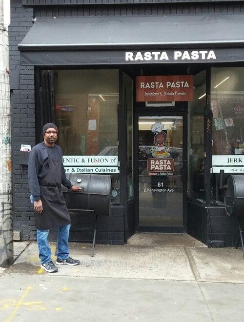 man standing outside rasta pasta restaurant in toronto 