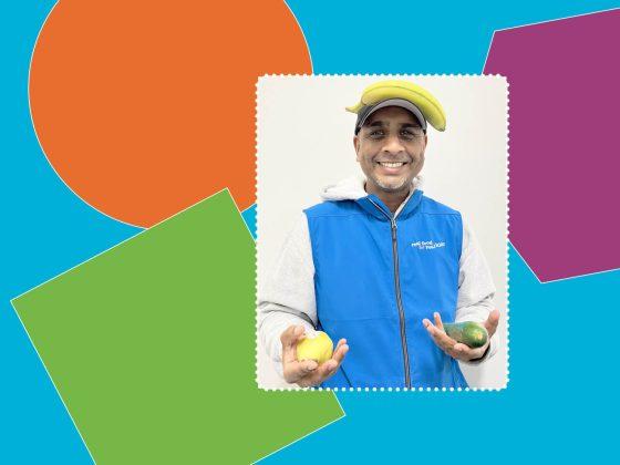 man with blue vest smiling in front of white background rectangle with larger colourful background with orange green and purple