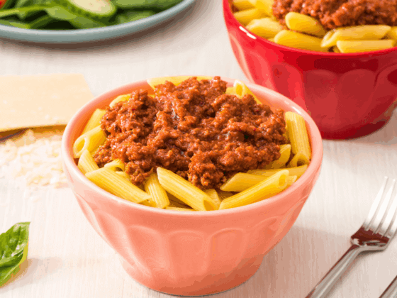 rfrk's beef bolognese recipe on top of penne in light red bowl