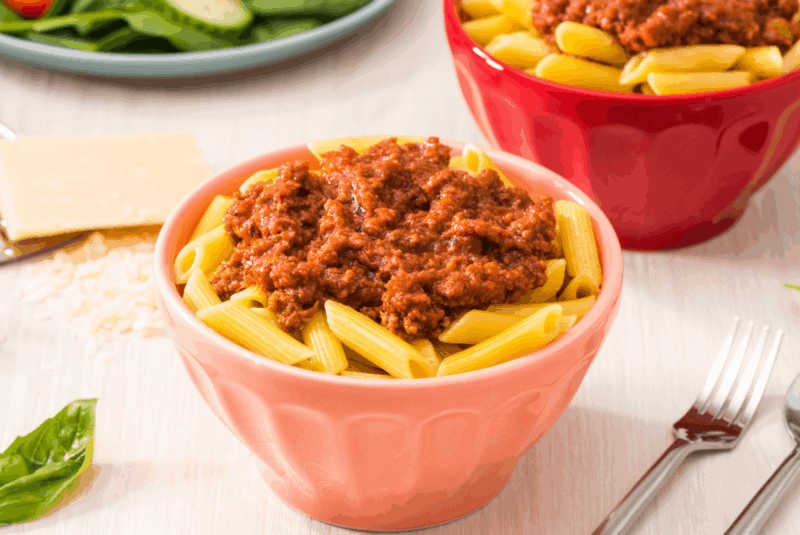 rfrk's beef bolognese recipe on top of penne in light red bowl