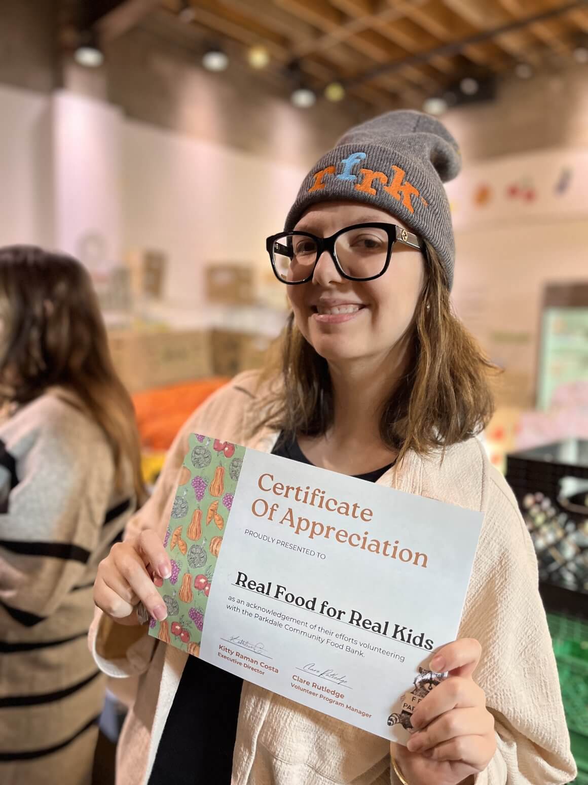 RFRK Volunteers at Parkdale Community Food Bank 2 rfrk team member holding certificate of appreciation for real food for real kids