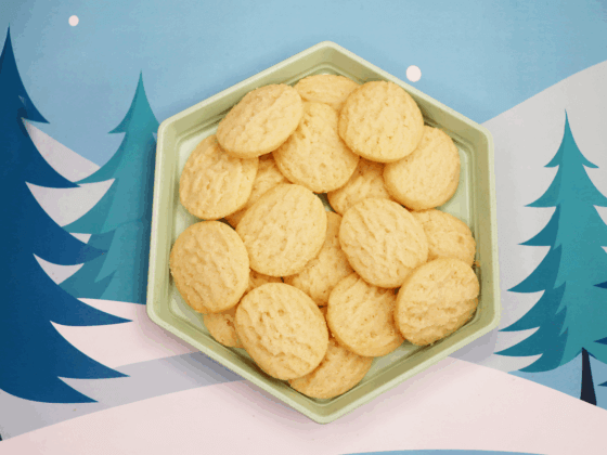 rfrk mini shortbread cookies on hexagonal mint green plate in front of winter scene background