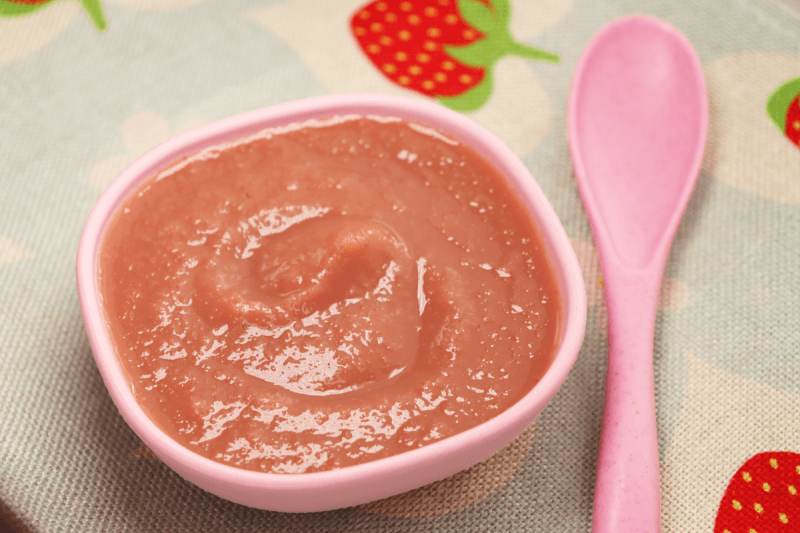 strawberry rhubarb sauce banner next to pink spoon sauce in a small pink bowl