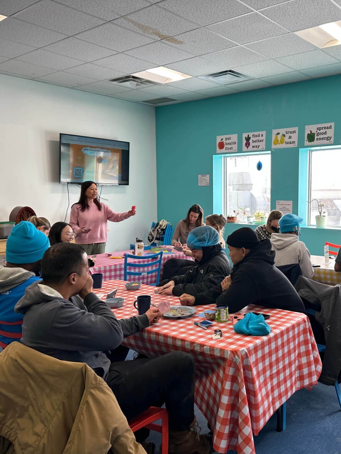rfrk staff seated around tables making origami together