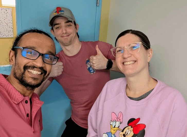 three rfrk staff smiling and posing with their pink shirts for pink shirt day