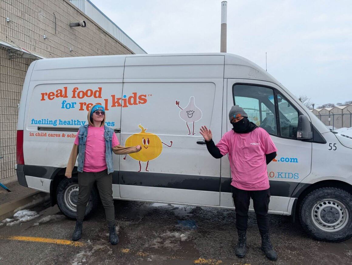 rfrk drivers wearing pink shirts for pink shirt day pointing at delivery van