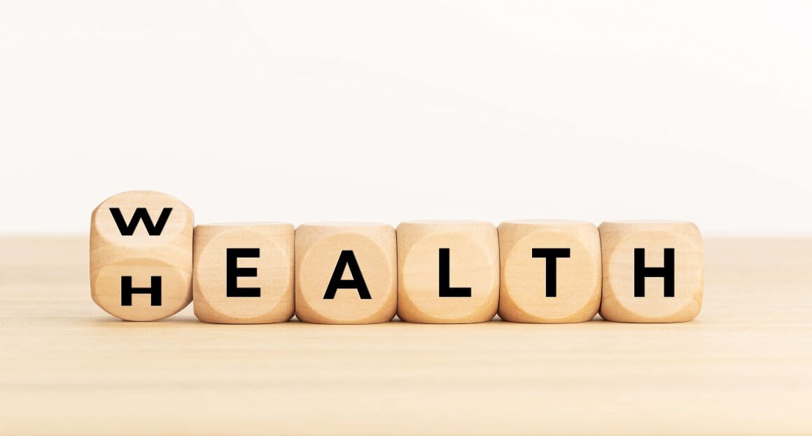 close up wealth / health spelled out in scrabble-style block letters