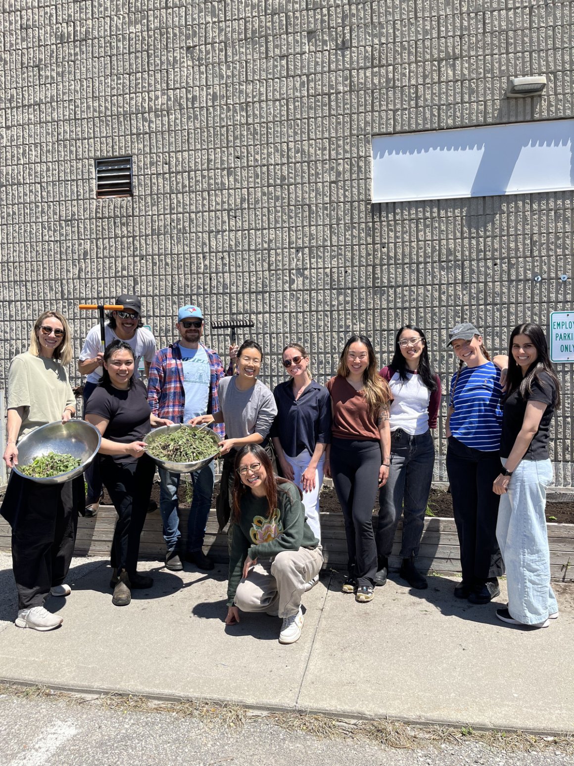 garden club! 3 group picture rfrk staff garden club posing outside of rfrk facility holding plants