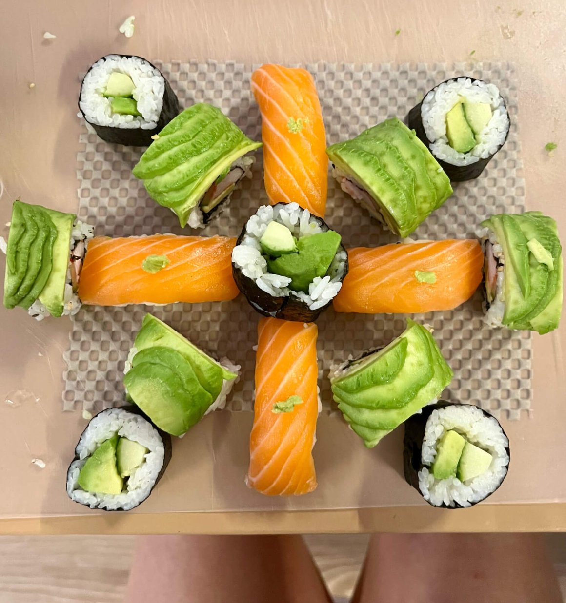 sushi arrangement showing salmon nigiri, vegetarian roll, green dragon roll