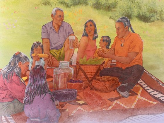 inside cover art for the great gathering place book depicting Indigenous people enjoying a feast