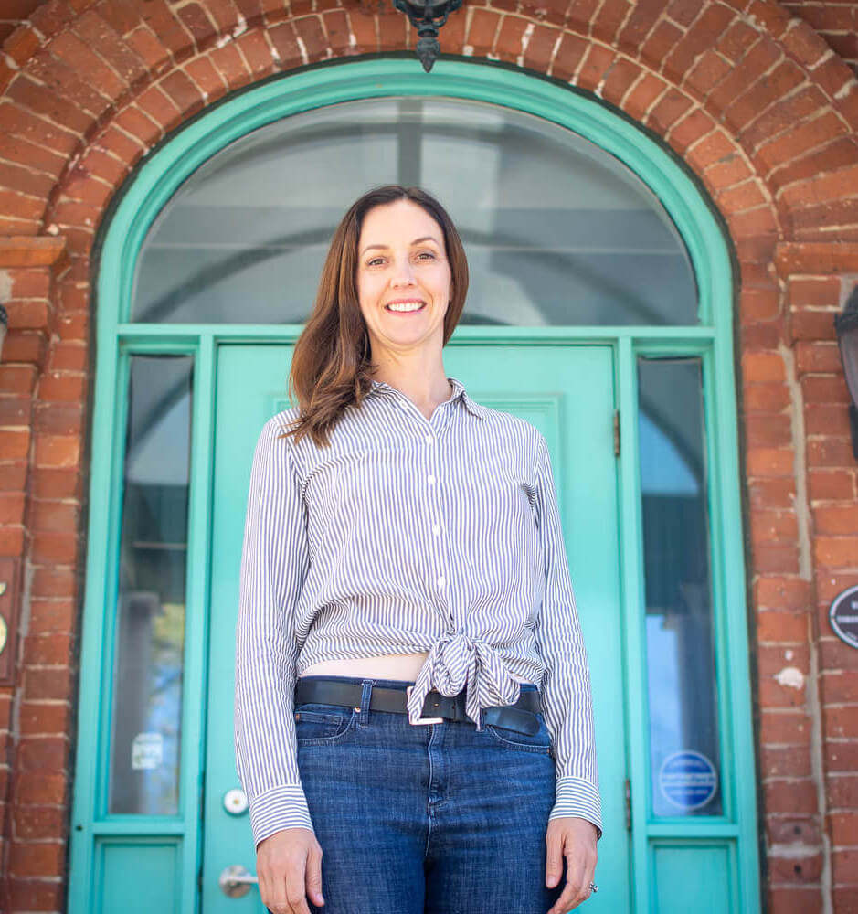 ECE professional liz smiling standing outside westside montessori building
